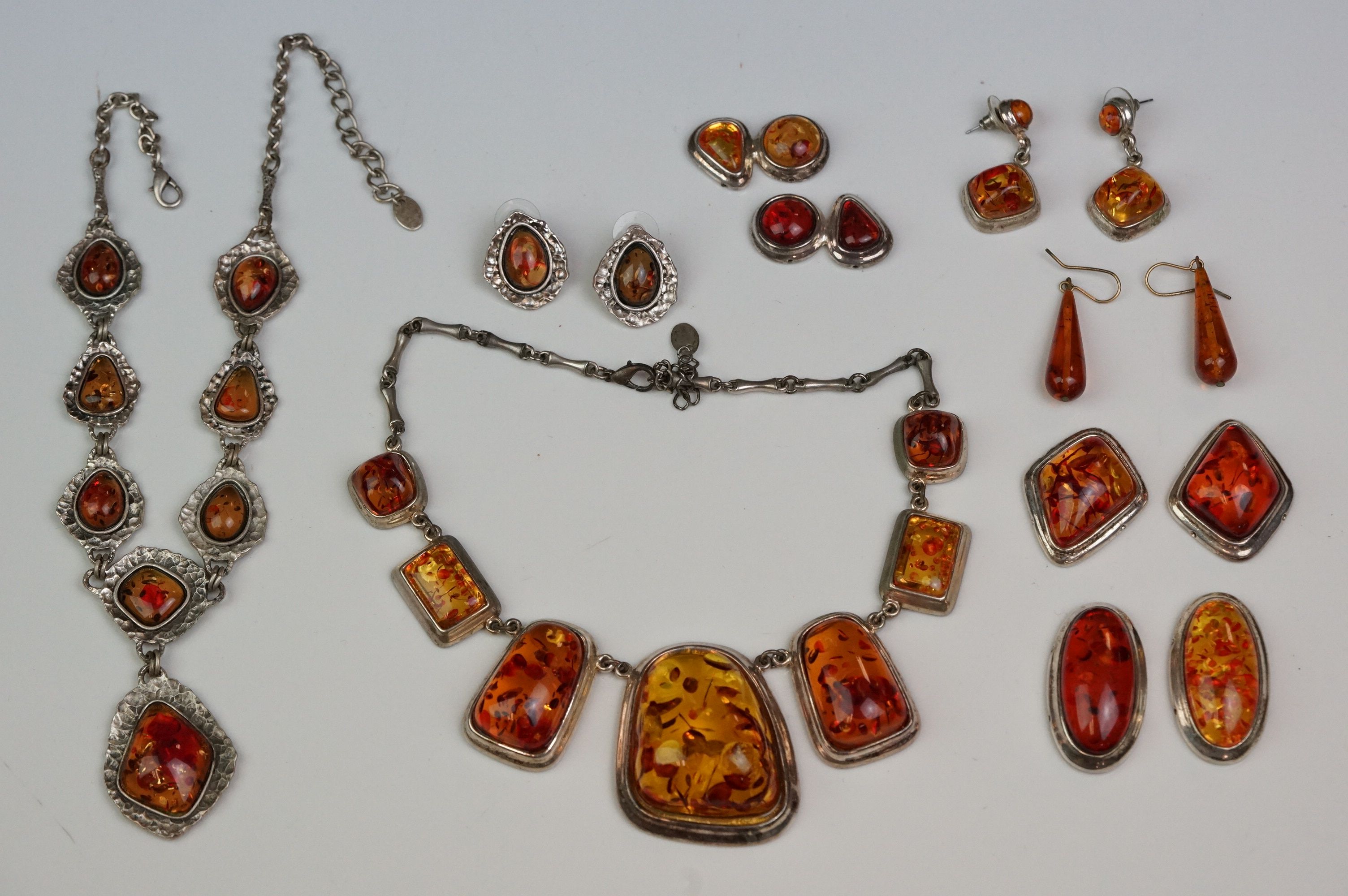 Amber jewellery to include amber graduated panel necklace, another similar, amber drop earrings etc