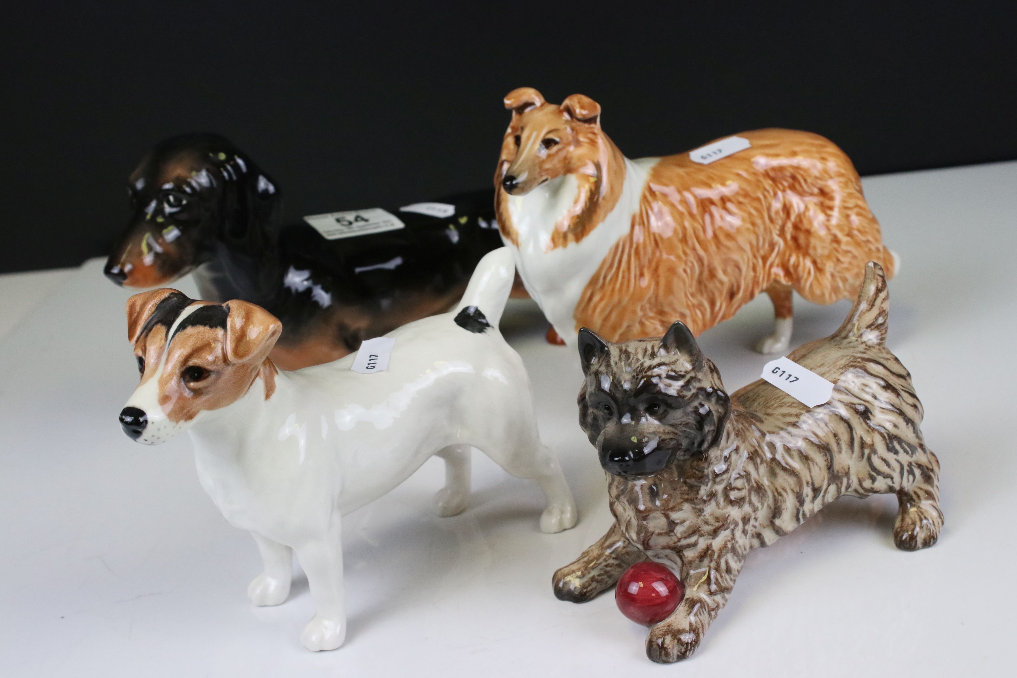 Four Beswick Dogs including Dachshund - standing (no. 361), Cairn Terrier with ball (no. 1055a),