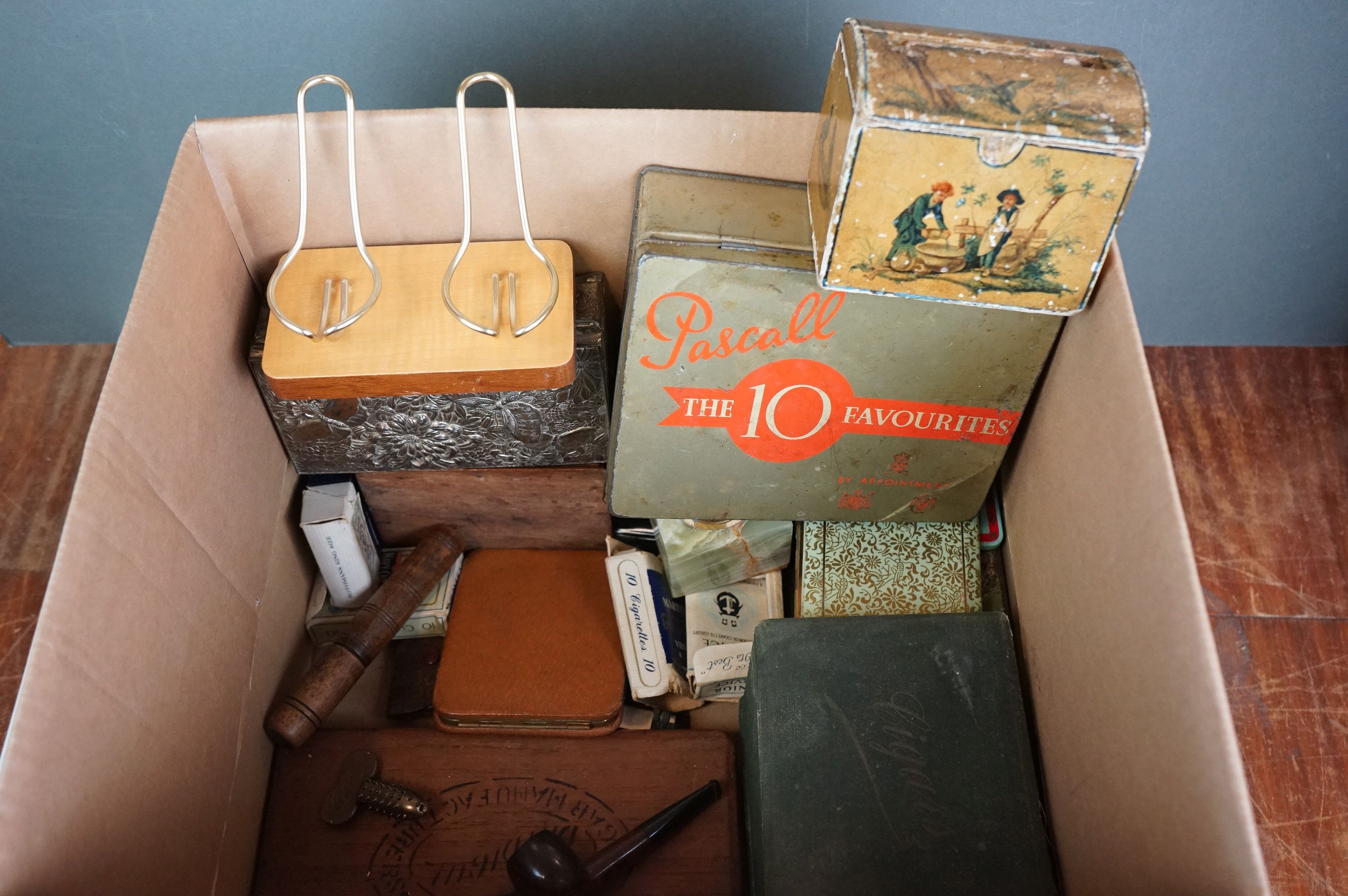 A box of mixed collectables cigarette dispenser, cigarette boxes, pipes etc