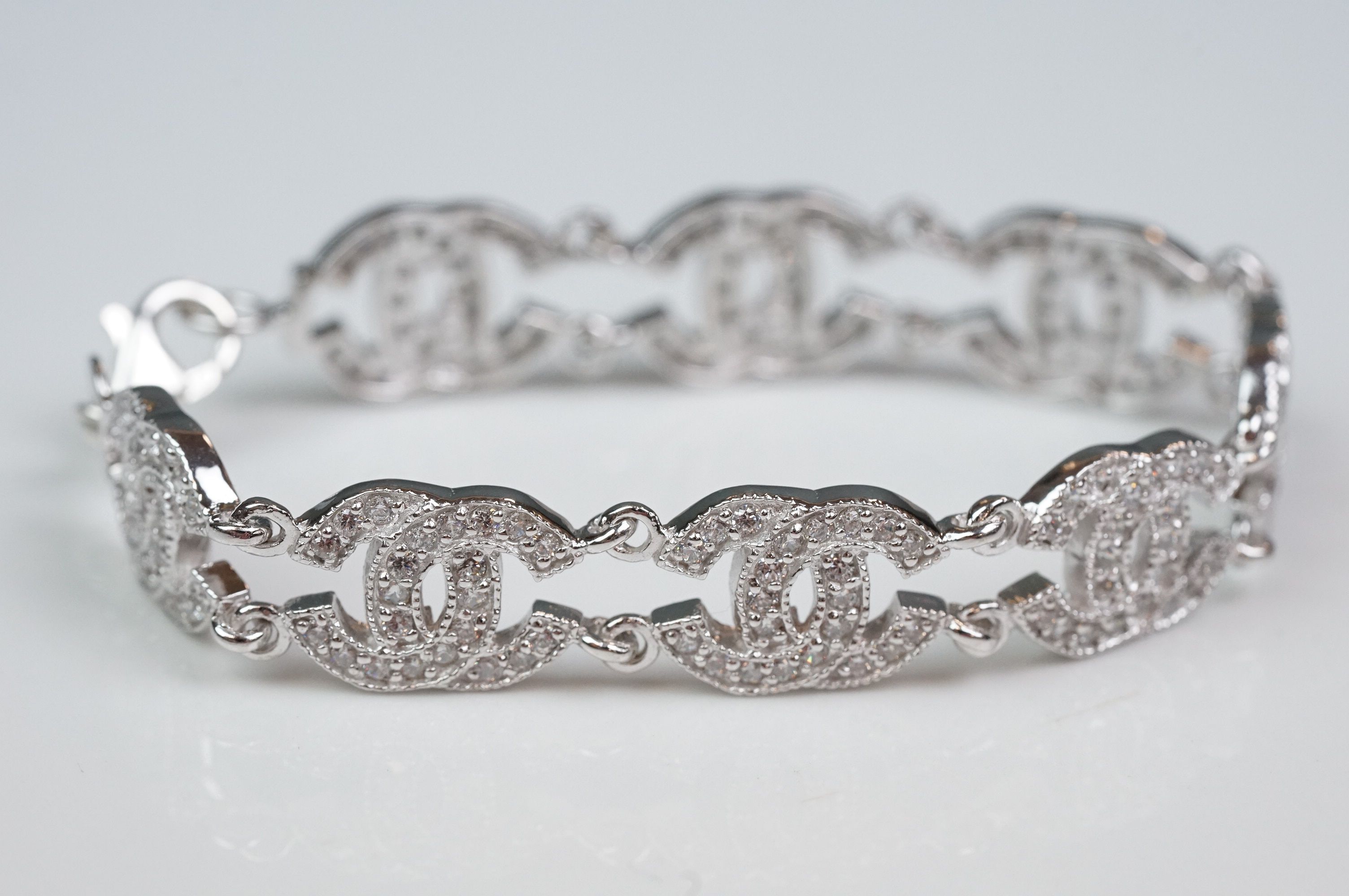 Silver and CZ set bracelet, in the Chanel style, set with eight double C links