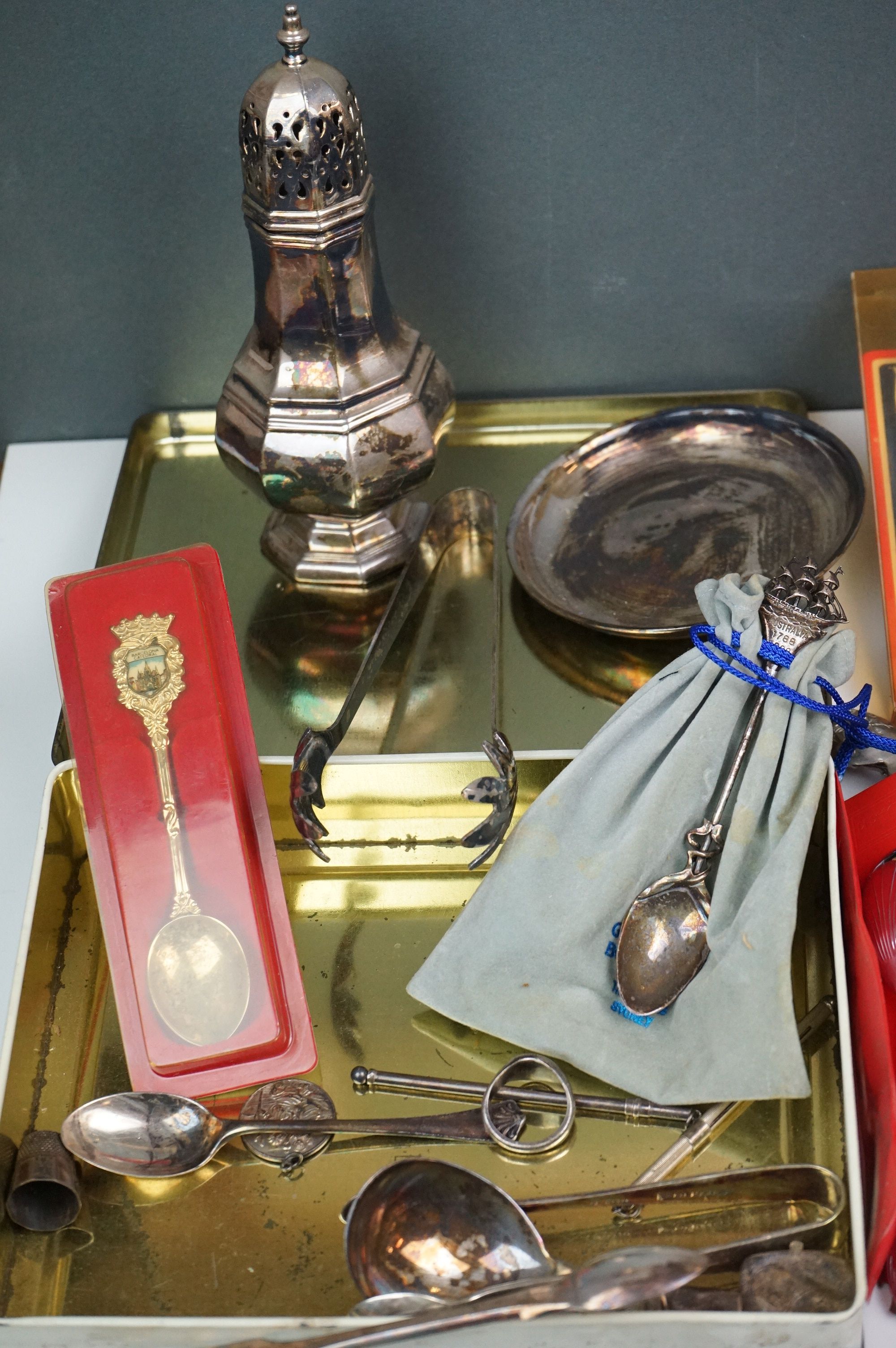 A mixed box of silver plated items to include collectors spoons, candle holder and sugar shaker. - Image 6 of 7