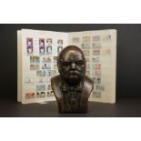 A Winston Churchill resin bust together with a collection of 1974 Commonwealth Churchill stamp sets.
