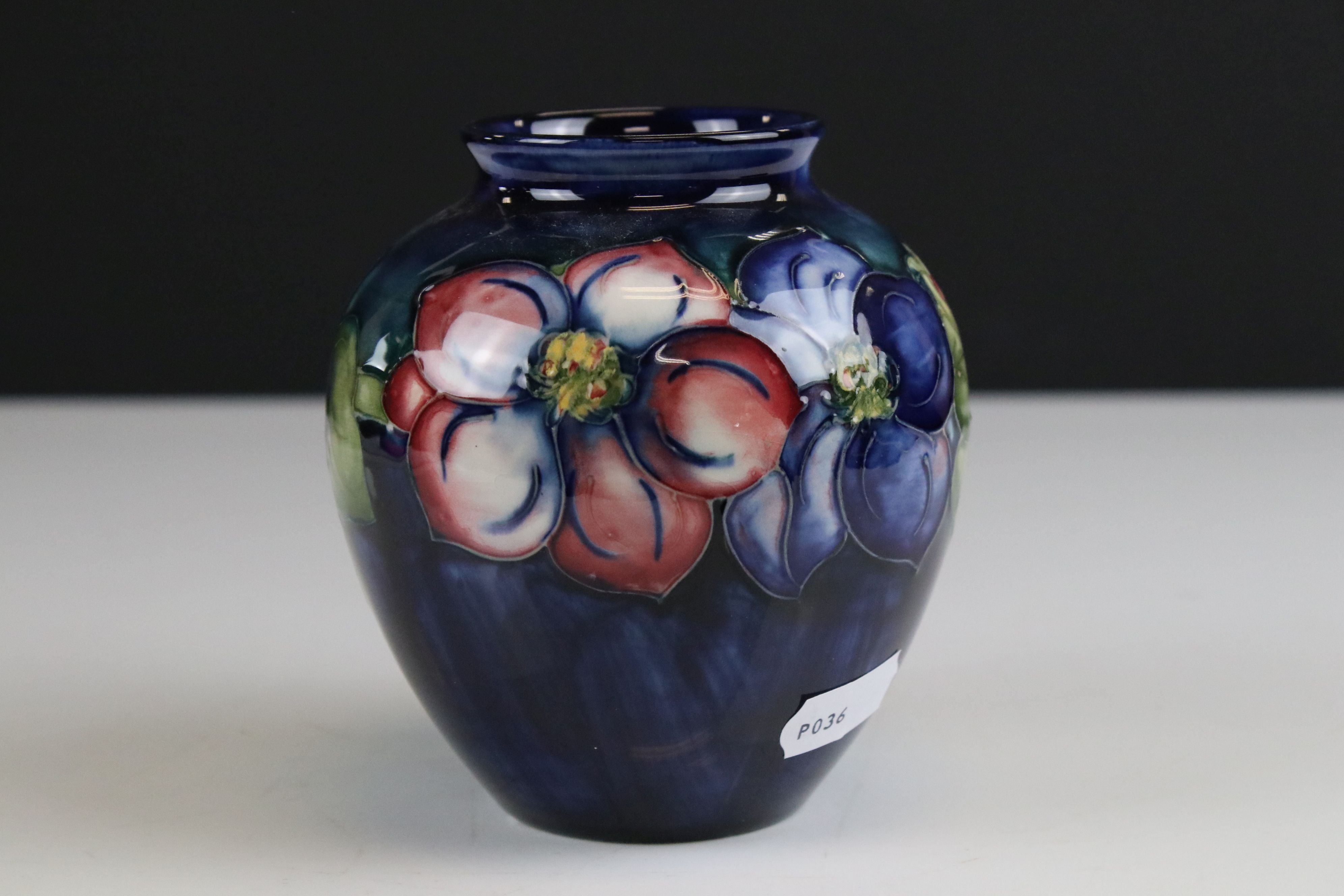 Moorcroft Vase in the Clematis pattern on a blue / green ground, marked to base an impressed