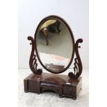 Victorian Mahogany Oval Swing Mirror held on carved scrolling brackets and a platform base with