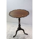 George III Mahogany Table with a circular moulded tilt top with pie crust edge, raised on a turned