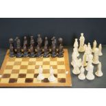 A resin figural chess set together with one piece wooden board.