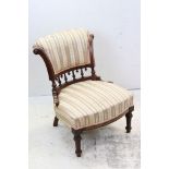Victorian Walnut Nursing Chair with upholstered scroll back and seat, spindle back and raised on