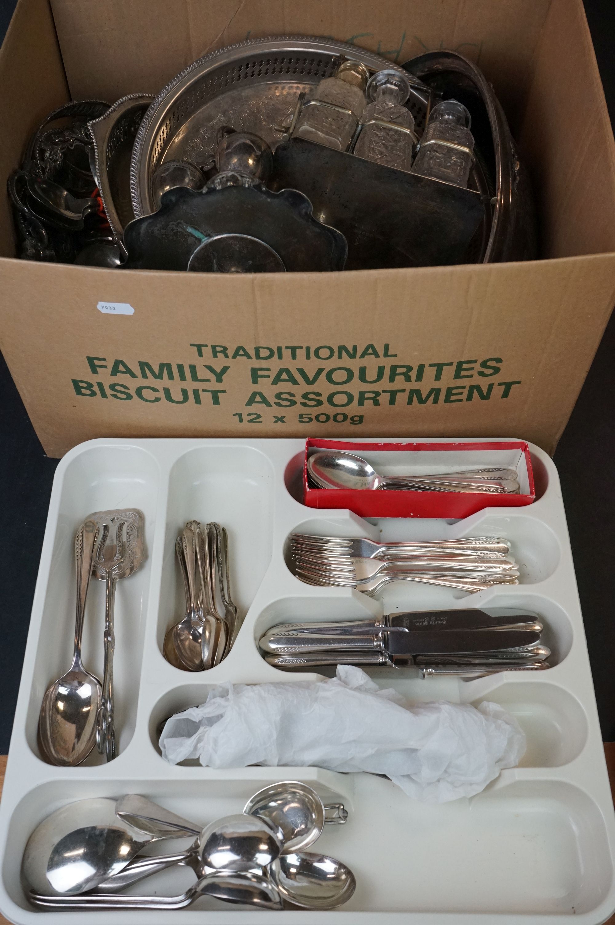 A box of mixed silver plated items to include cutlery, toast rack, trays, condiment set and