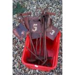 A set of painted metal croquet marker flags.