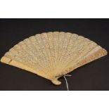 A antique Oriental carved ivory folding Brise fan.