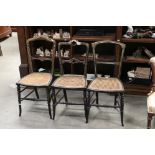 Three Victorian Black Lacquered Chairs with Gilt and Mother of Pearl decoration, cane seats