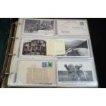 A large collection of vintage postcards contained within an album to include real photograph and