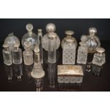 A collection of vintage scent and dressing table bottles to include many silver topped and collard