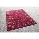 Rich red ground full pile Turkmen double knot carpet, with allover Bokhara design, approx. 290cm x