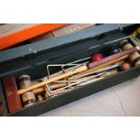 A wooden cased garden Croquet set, appears complete with Mallets, balls and hoops.