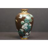A Chinese cloisonné vase with fine decoration of birds and flora, character marks to base.