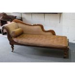 Victorian Walnut Chaise Lounge with shaped back and scroll end, upholstered in brown fabric with a