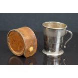 A vintage folding stirrup cup with folding handle complete with brown leather case.