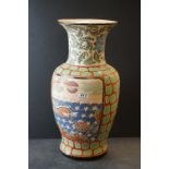 A pair of oriental Cloisonné vases with floral decoration on wooden stands together with a