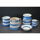 A collection of blue & white Cornish ware pottery to include sugar jar, jugs, bowl and mug.