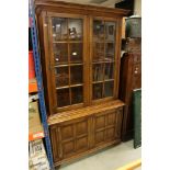 Oak Display Cabinet in the 18th century manner with Glazed Doors above Panel Doors raised on ball
