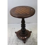 Victorian Walnut Circular Games Table, the top inlaid with a Rosewood and Boxwood Chess Board,