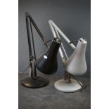 Two angle poise desk lamps to include a black and a silver example.