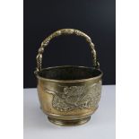 Japanese Brass Bowl with Swing Handle with raised decoration of a Dragon, 18cms diameter