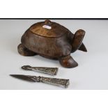A wooden lidded trinket box in the form of a tortoise together with an Argentinian knife.