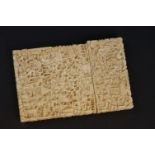 An antique oriental heavily carved two piece Ivory card case.