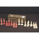 A vintage carved bone chess set in metal box.
