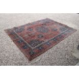 Red and Blue Ground Rug with stylised floral pattern