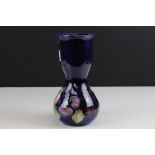William Moorcroft Vase of waisted form decorated in the Pansy pattern on a blue ground, blue