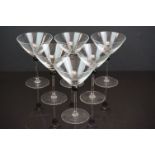 A set of eight hand blown delicate Martini glasses with large twisted black bead at the throat of