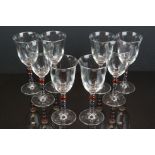 A set of eight Italian wine glasses with coloured beaded stems.