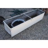 A large painted galvanised feeding trough together with a galvanised foot bath.