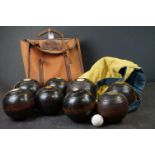 Two sets of four vintage bowling balls.