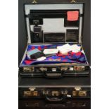 A large collection of Masonic regalia contained within two briefcases to include Aprons, booklets