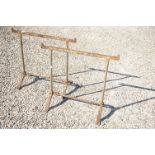 A pair of wrought iron decorators trestles.