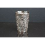 An early twentieth century Indian silver beaker with ornate decoration.
