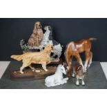 A collection of three Russian ceramic horses together with two contemporary dog ornaments.