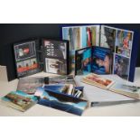 A collection of mixed vintage and contemporary postcards contained within albums together with loose