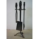 A vintage wrought iron companion set.