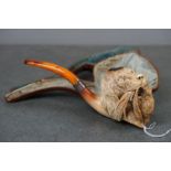 A large oversized finely carved meerschaum pipe in the form of a hunting dog, with amber