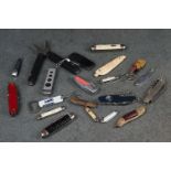 A collection of mainly modern pocket knives and multi tools.