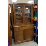 Late 19th century Oak Glazed Bookcase over Cupboard, the upper section with twin glazed door over