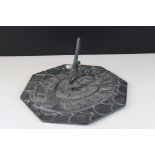 Octagonal lead sundial with winged figure to centre, approx. 30cm diameter
