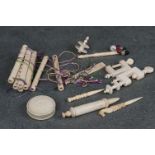 A collection of antique Ivory to include pin cushion, vices and a threaded game.