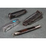 A collection of four vintage pocket knives to include military jack knife examples.