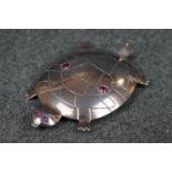 A vintage sterling silver brooch in the form of a turtle.
